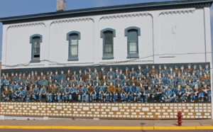 Large mural of historic workers in Powderhorn Village, a unique Upper Peninsula vacation attraction.