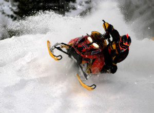 Snowmobiler riding on winter trails near Big Powderhorn in the U.P. Extreme winter sport action.
