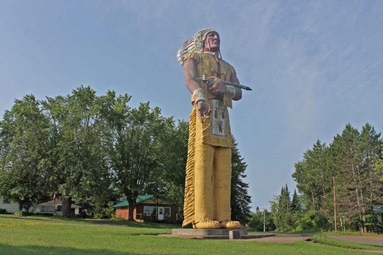 Large statue of an Indigenous man in Powderhorn Village, a unique attraction near Big Powderhorn Mountain.