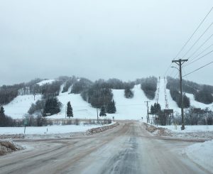 Big Powderhorn Mountain ski resort in winter, with snow-covered slopes and ski lifts. Powderhorn Village skiing.