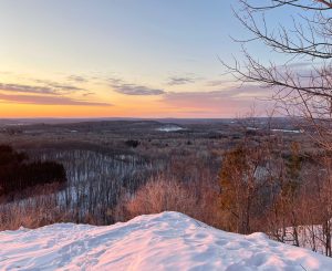 Sunset view of snow-covered landscape near Big Powderhorn Mountain, perfect for Powderhorn Village skiing.
