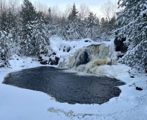 Snowy waterfall near Big Powderhorn Mountain, a beautiful winter scene for Powderhorn Village skiing.