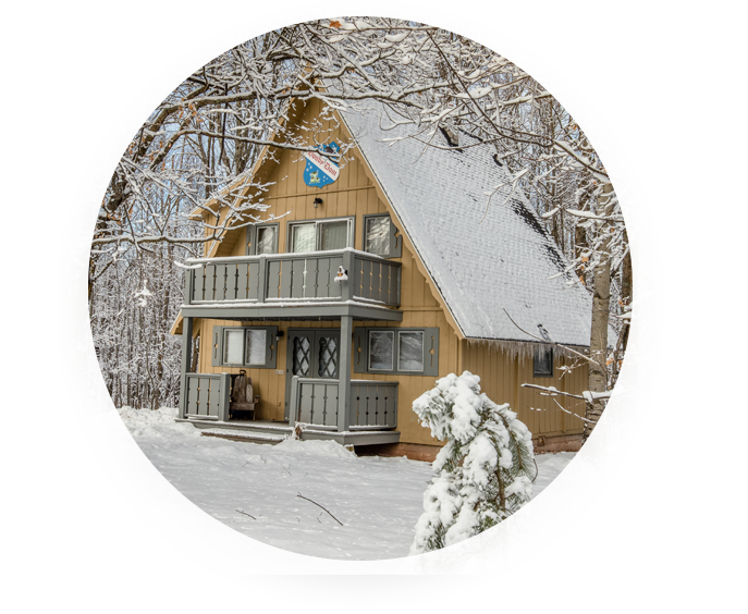 A-frame cabin in winter, promoting Big Powderhorn lodging specials for a Powderhorn Village vacation.