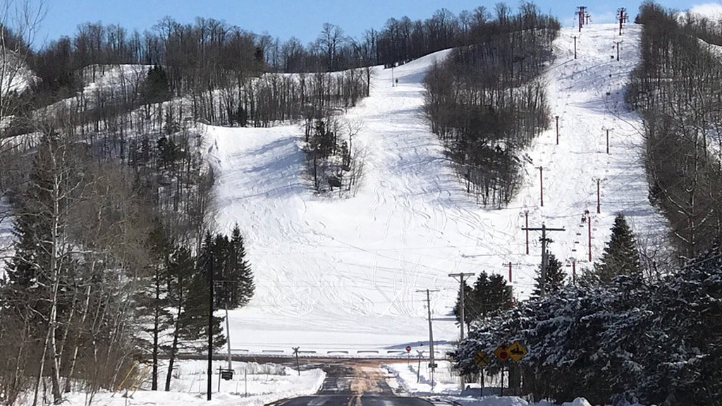 Big Powderhorn Mountain ski resort in winter, with groomed slopes and chairlifts.