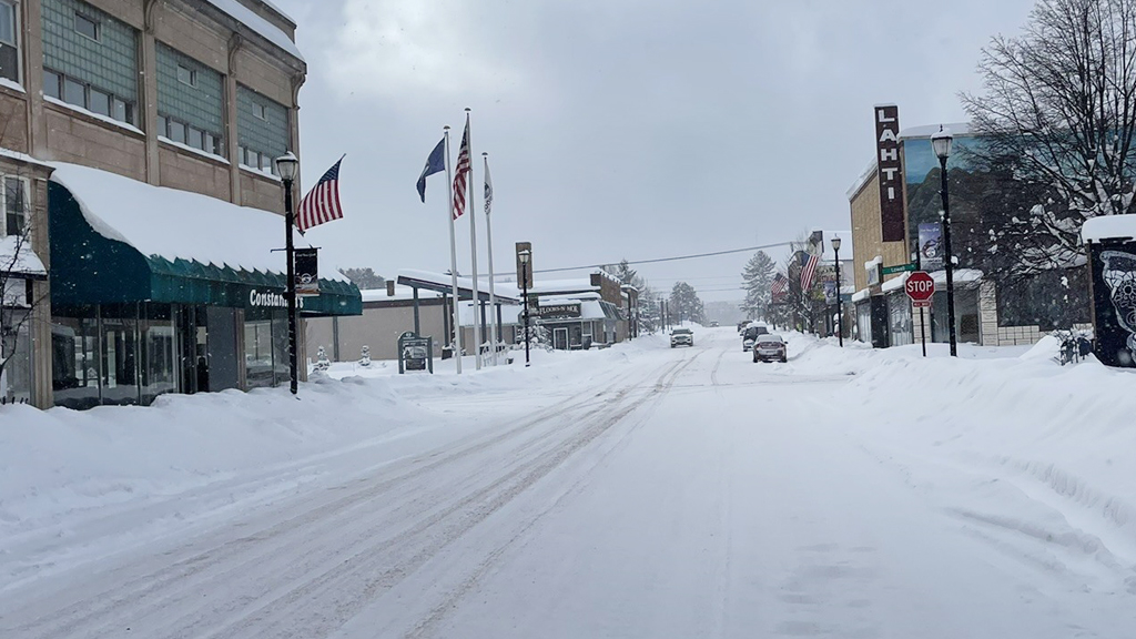 Snowy street in Upper Peninsula town, a scenic winter destination for activities.