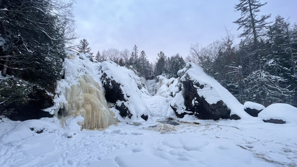 Frozen waterfall in Michigan's Upper Peninsula in winter, a great winter activity.