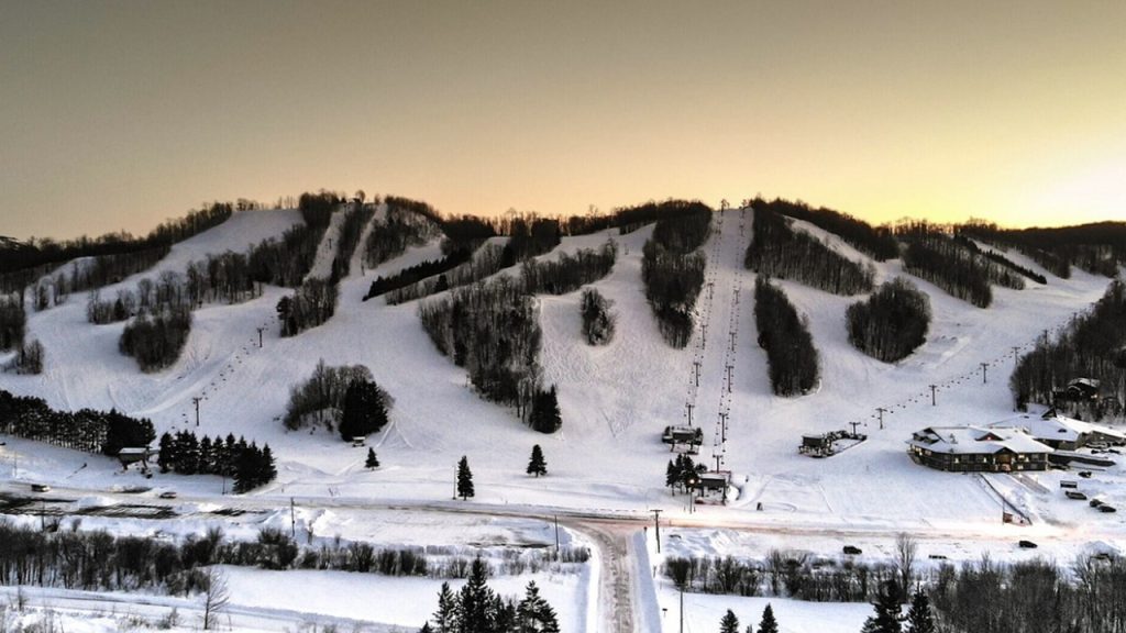 Snowy ski resort with ski lifts and lodge, one of the ski areas near Big Powderhorn Lodging.