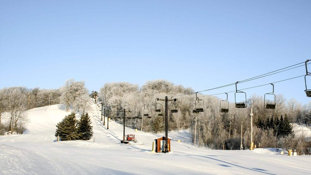 Ski lift at a snowy ski resort, a winter scene near Big Powderhorn Lodging.