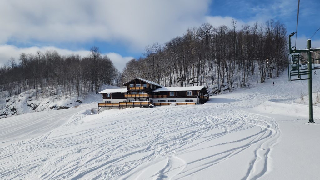 Ski lodge at ski area near Big Powderhorn Lodging, with ski slopes and trees.