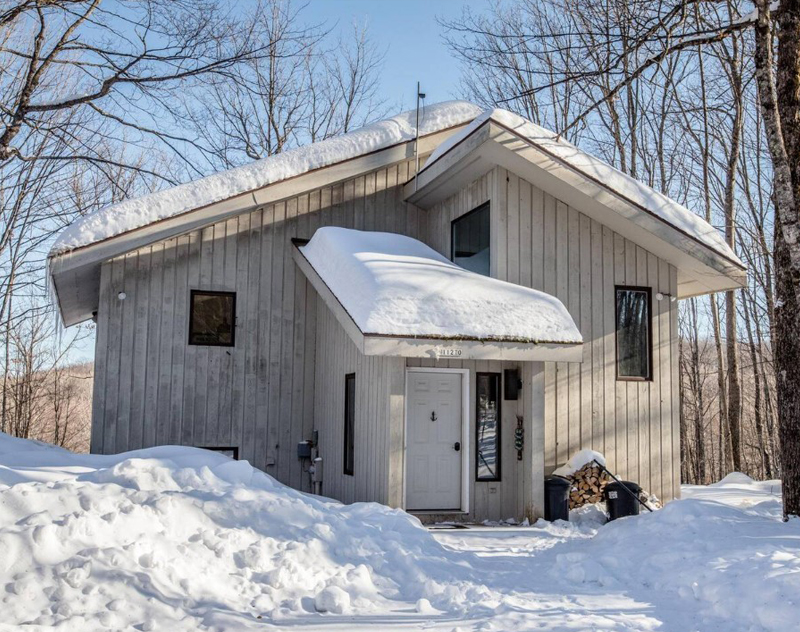 Cozy Big Powderhorn Lodging winter cabin surrounded by snow.